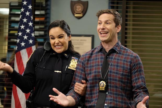 Melissa Fumera as Amy Santiago and Andy Samberg as Jake Peralta