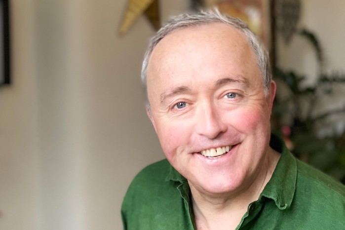 Marcus Bentley wearing a green shirt, smiling into camera